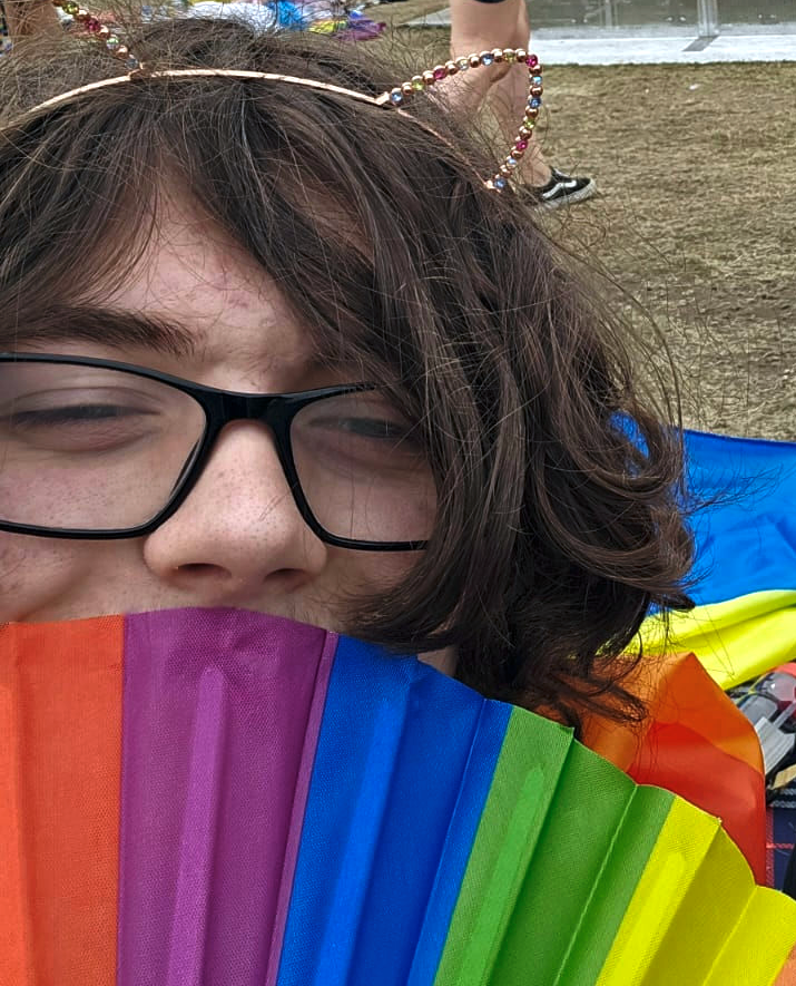 Pic of me at Pride with a gay handfan, wearing cute ears, being very gae and looking like a girl for once!!!!